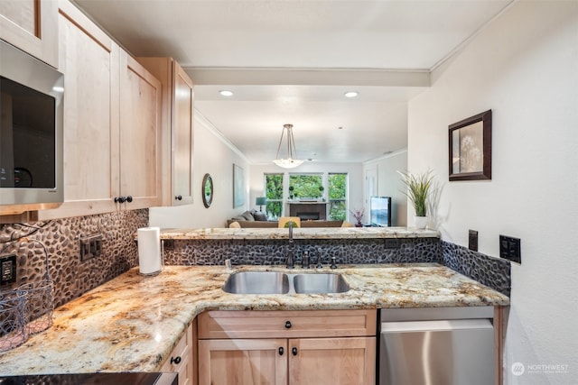 kitchen featuring crown molding, stainless steel appliances, light brown cabinetry, and sink