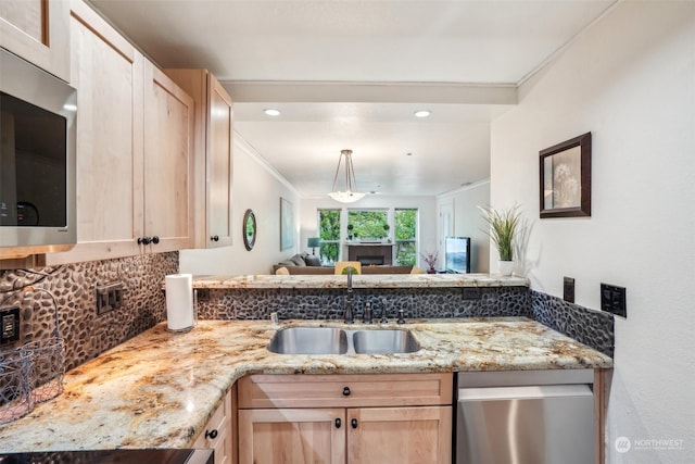 520 SE Columbia River Dr Unit 120, Vancouver, WA 98661 - kitchen featuring light brown cabinetry, a sink, open floor plan, backsplash, and stainless steel appliances