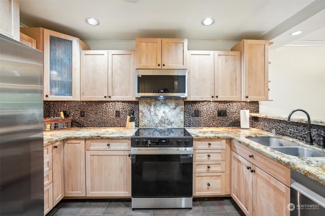 kitchen featuring light brown cabinetry, sink, appliances with stainless steel finishes, and light stone countertops