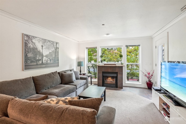 tiled living room with crown molding and a tiled fireplace