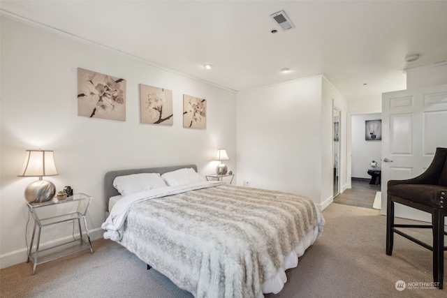 bedroom with crown molding and light carpet