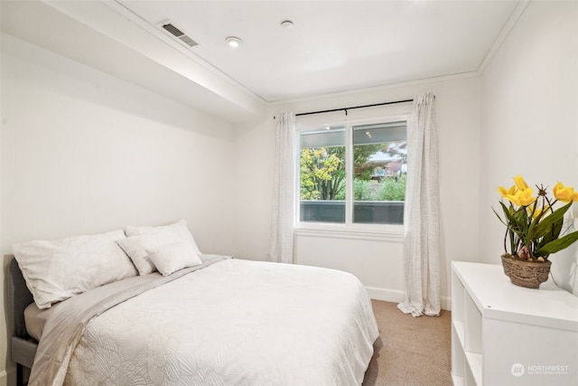 carpeted bedroom featuring crown molding