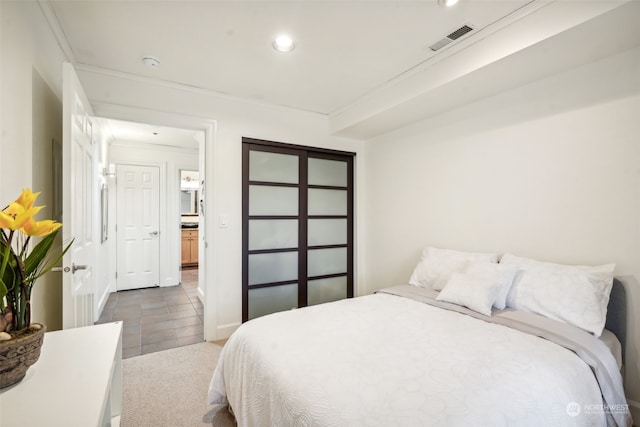 bedroom featuring crown molding and dark colored carpet