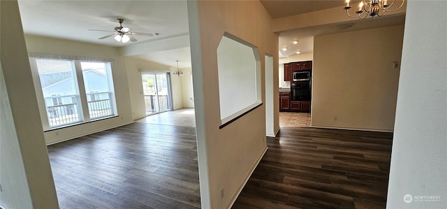 corridor featuring a notable chandelier and dark hardwood / wood-style flooring