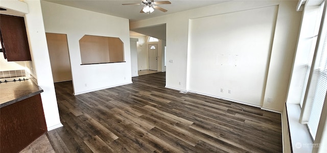 interior space with ceiling fan and dark hardwood / wood-style flooring