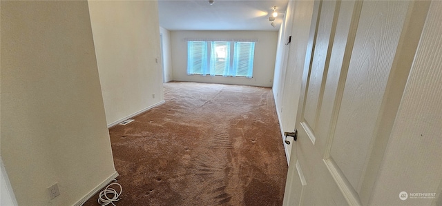 hallway featuring carpet flooring