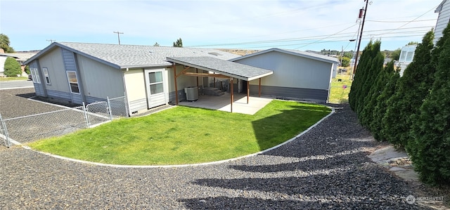 back of house with a lawn and a patio area