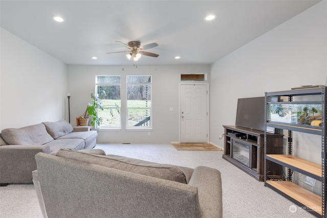 living room featuring ceiling fan and light colored carpet