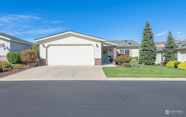 ranch-style home with a garage and a front lawn