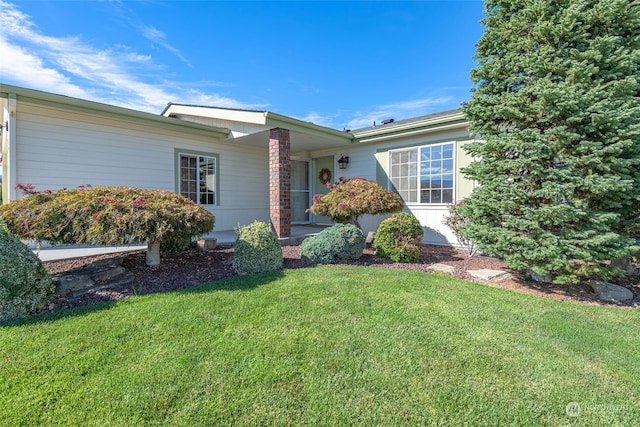 ranch-style home with a front lawn