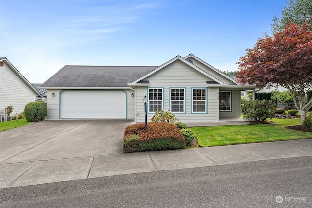 ranch-style house featuring a front lawn and a garage