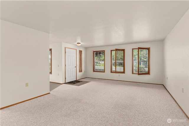 unfurnished room featuring carpet flooring