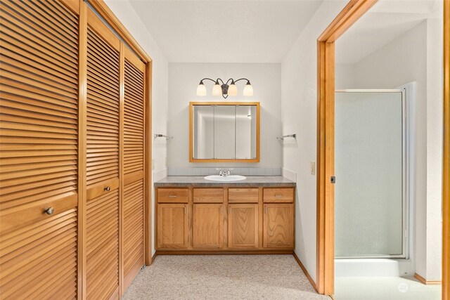 bathroom featuring vanity and an enclosed shower