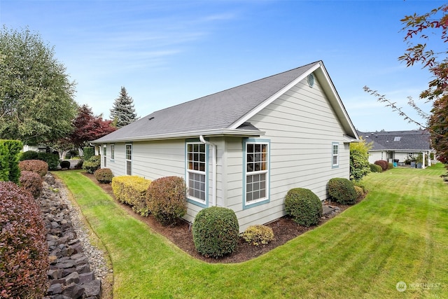 view of property exterior with a yard