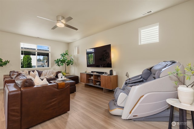 living room with ceiling fan and light hardwood / wood-style flooring