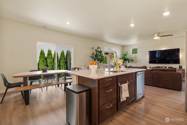 kitchen featuring ceiling fan, a center island with sink, sink, and a wealth of natural light