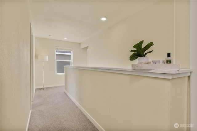 hallway featuring light carpet