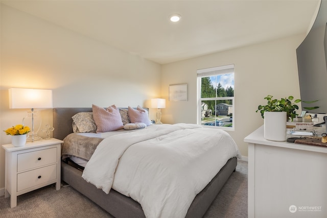 bedroom featuring light carpet