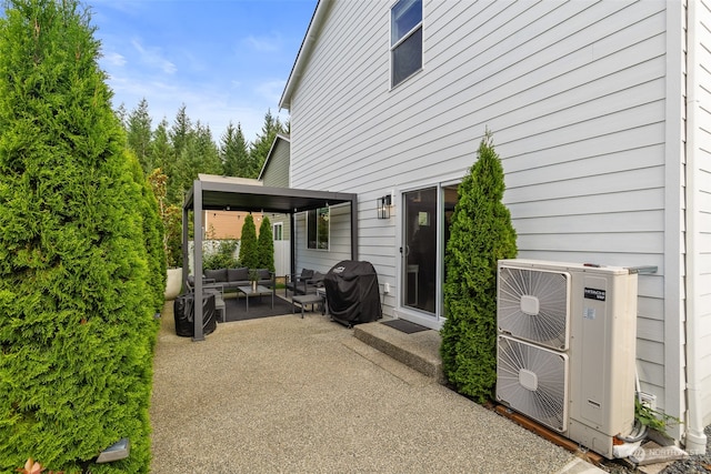 view of patio featuring an outdoor hangout area, ac unit, and a grill