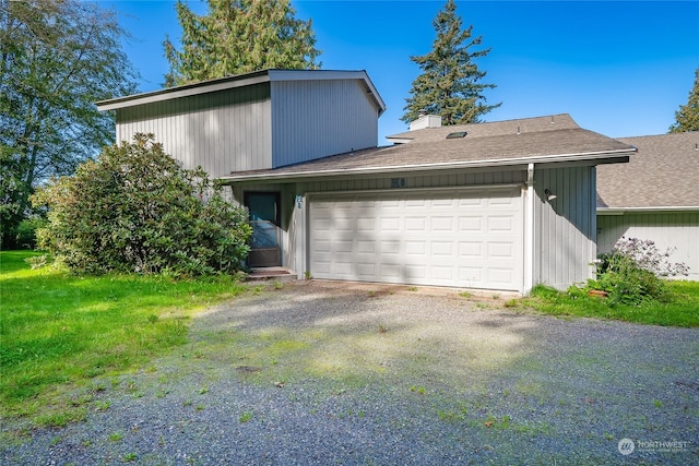 2879 N Nugent Rd Unit H8, Lummi Island, WA 98262 - view of front of home with an attached garage, a shingled roof, and a chimney