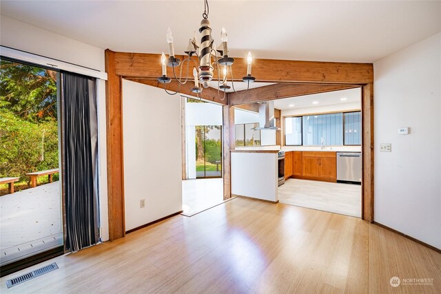 2879 N Nugent Rd Unit H8, Lummi Island, WA 98262 - kitchen with appliances with stainless steel finishes, a chandelier, light wood-style flooring, and light countertops