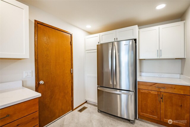 2879 N Nugent Rd Unit H8, Lummi Island, WA 98262 - kitchen featuring freestanding refrigerator, light countertops, white cabinetry, brown cabinets, and recessed lighting