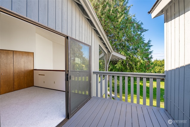 wooden deck featuring a lawn