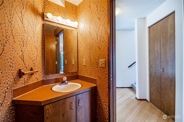 bathroom featuring hardwood / wood-style flooring and vanity