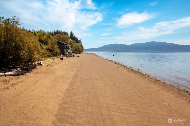 view of water feature featuring a view of the beach and a mountain view