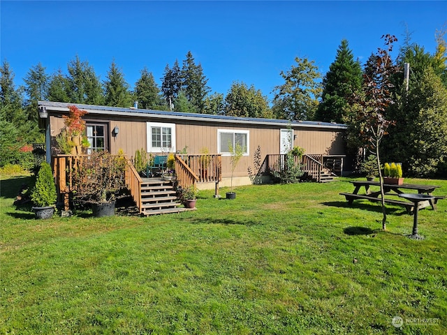 rear view of house featuring a yard