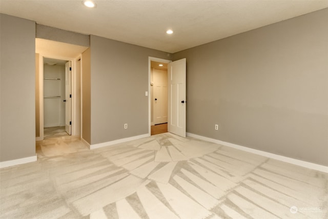 unfurnished bedroom with light carpet