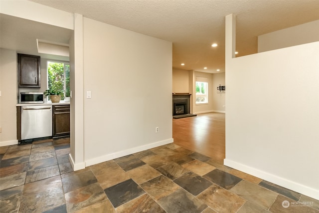 unfurnished room with a textured ceiling