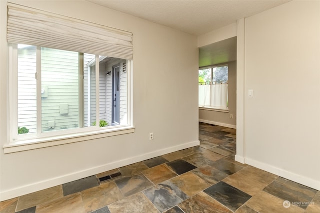 spare room featuring a textured ceiling