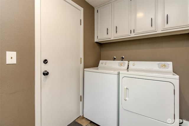 laundry room featuring independent washer and dryer and cabinets