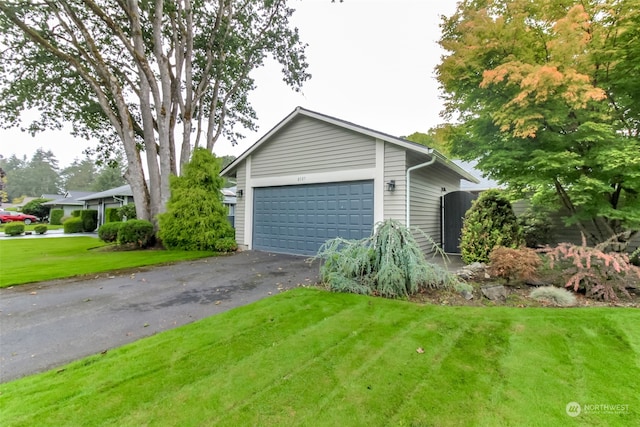 exterior space featuring a garage and a yard