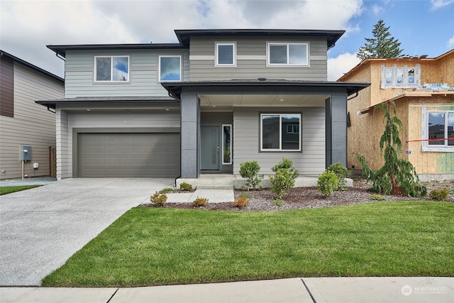 view of front facade with a garage and a front lawn