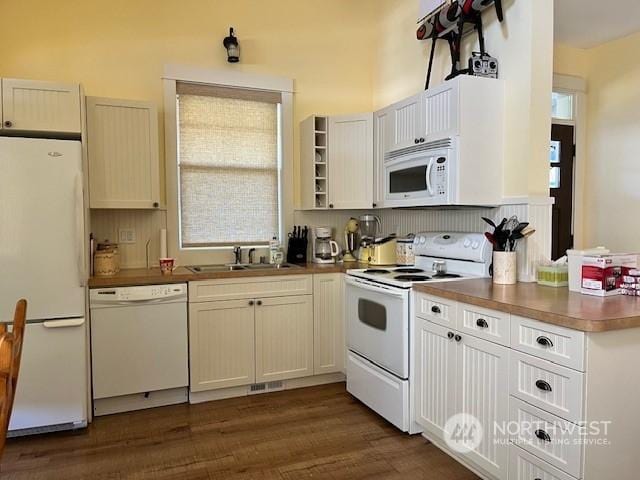 117 Barefoot Ln E, Oroville, WA 98844 - kitchen with white appliances, a sink, dark wood-style floors, decorative backsplash, and dark countertops