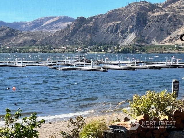 view of dock featuring a water and mountain view