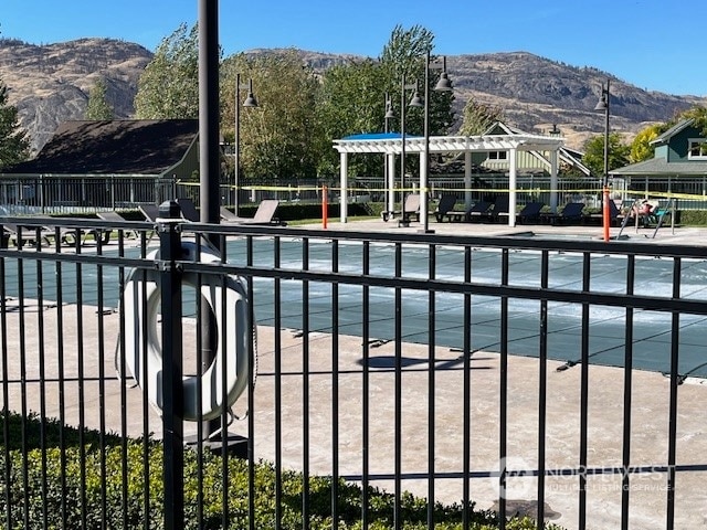 view of swimming pool featuring a mountain view and a gazebo