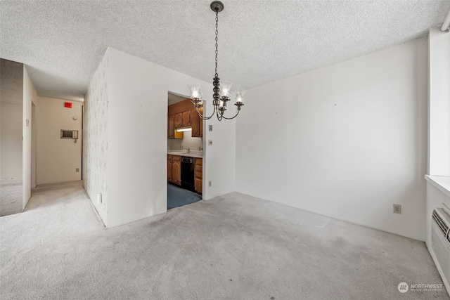 unfurnished dining area with a textured ceiling, sink, light colored carpet, and a notable chandelier