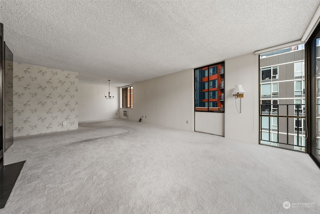 unfurnished living room with carpet floors and a textured ceiling