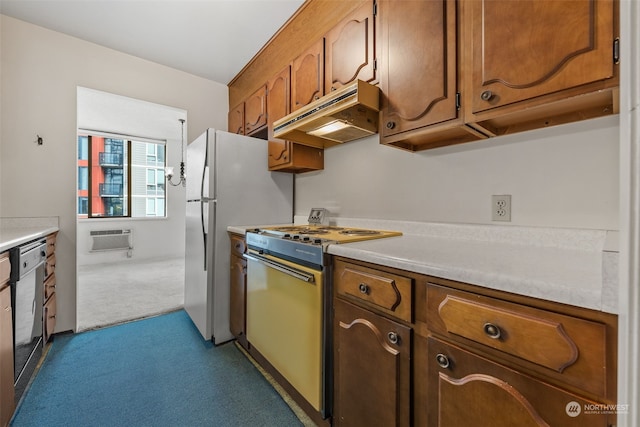 kitchen with light colored carpet, appliances with stainless steel finishes, and a wall mounted AC