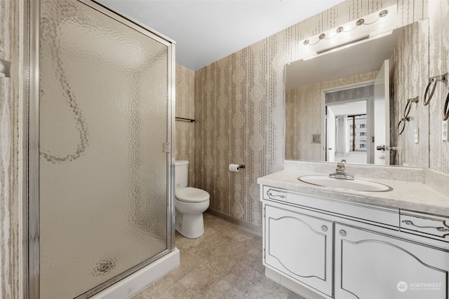 bathroom with vanity, toilet, and an enclosed shower