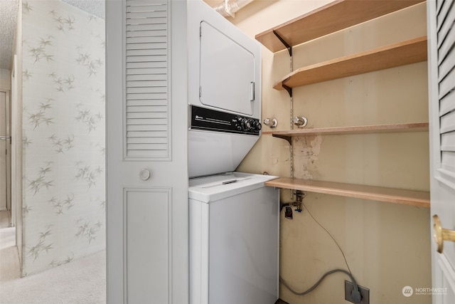 laundry area with stacked washer / drying machine and carpet flooring