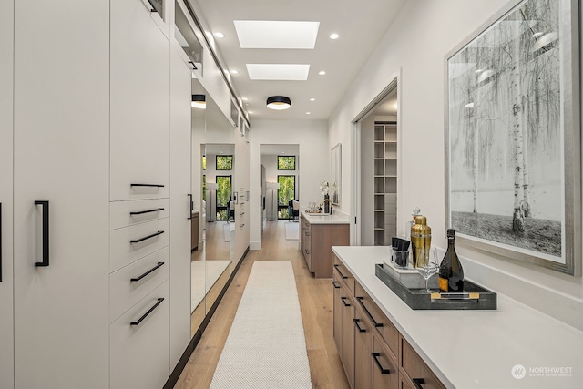 interior space featuring white cabinets and light hardwood / wood-style flooring