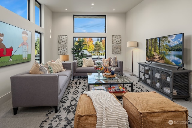 carpeted living room with a high ceiling