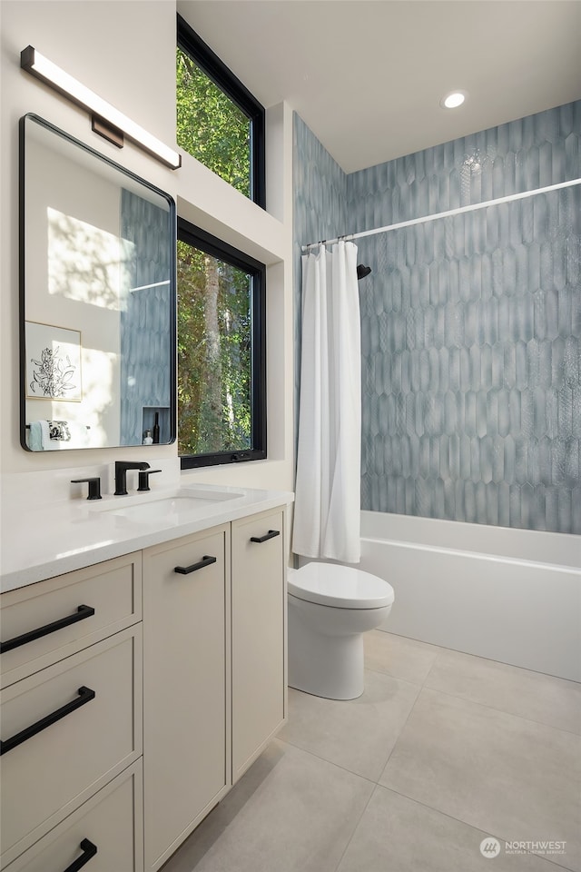 full bathroom featuring vanity, toilet, shower / bath combo with shower curtain, and tile patterned floors