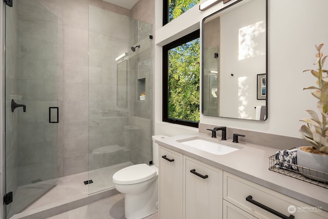 bathroom with vanity, toilet, an enclosed shower, and tile patterned floors