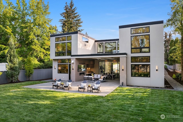 back of house with outdoor lounge area, a yard, and a patio area