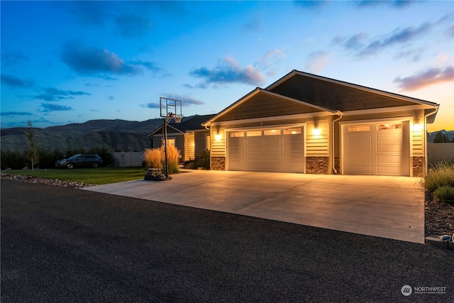 view of front of home with a mountain view and a garage